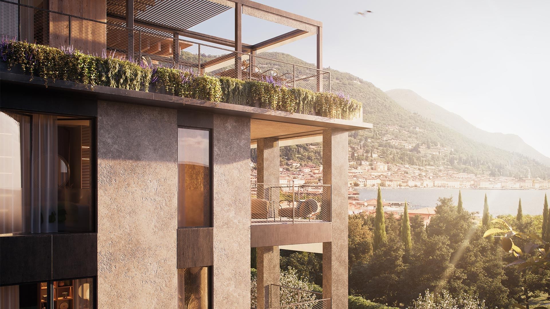 Modernes Gebäude mit Terrasse und Blick auf eine bewaldete Landschaft und einen See.